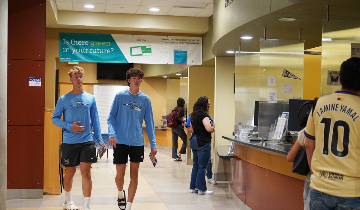 Two students walking by WVC Financial Aid office in Wenatchee