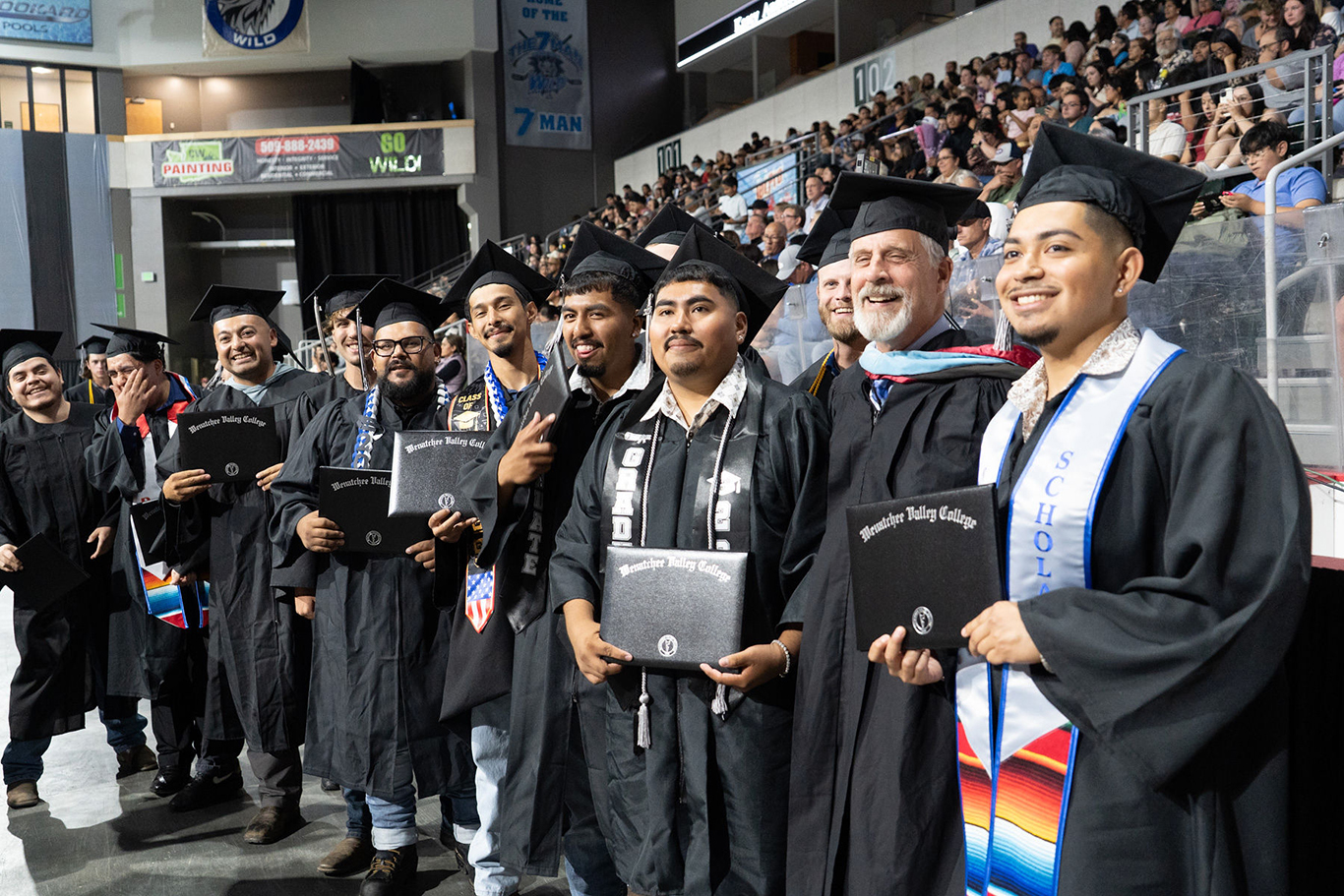 Students with Professor Greg Jourdan at graduation