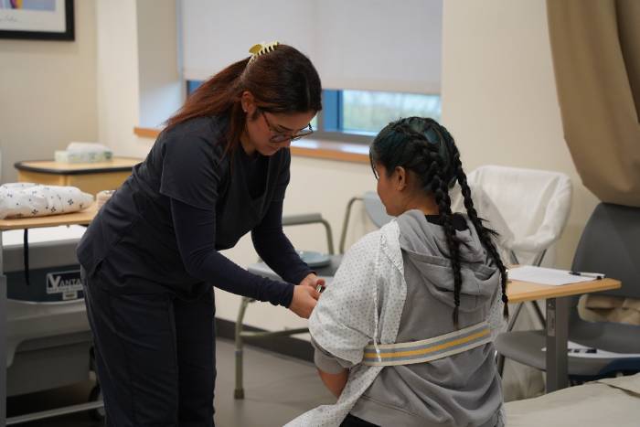 Two students practicing skills in the lab.