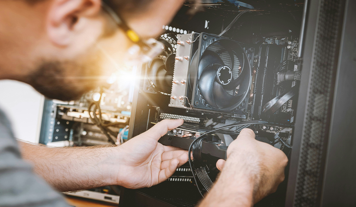 A computer technician works on a computer's operating system.