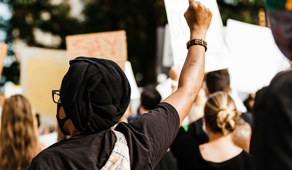 A view at the back of people at a protest.
