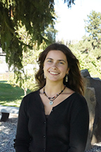 Portrait of Ava Burk standing outside beneath a tree