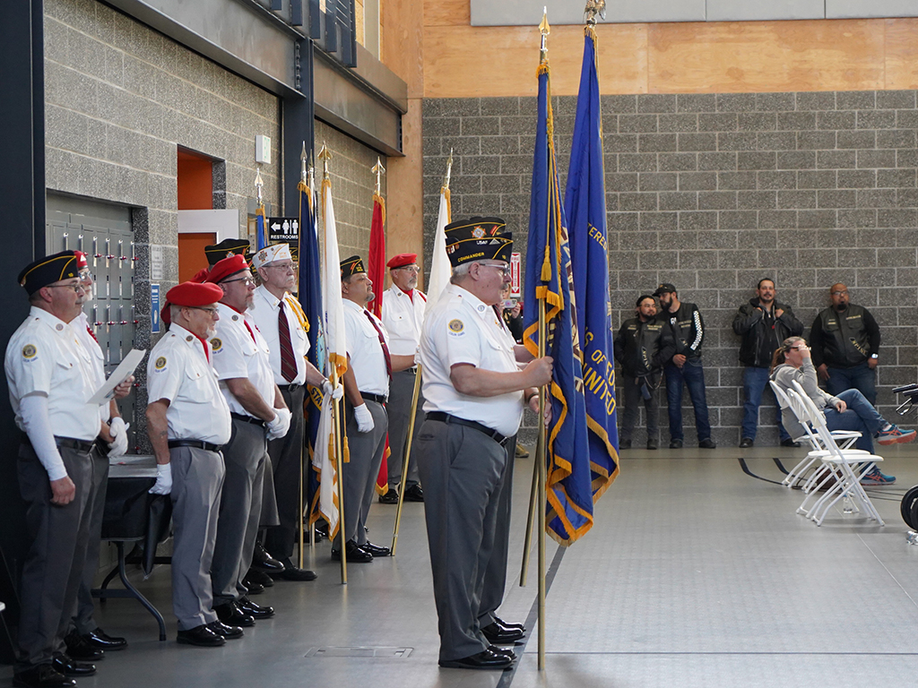 A group of veterans stand together in uniform.